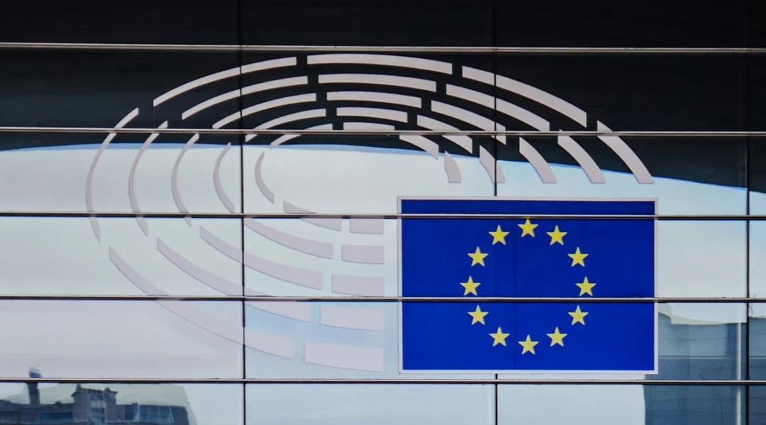 EU flag and Parliament building, reflecting EU Omnibus changes