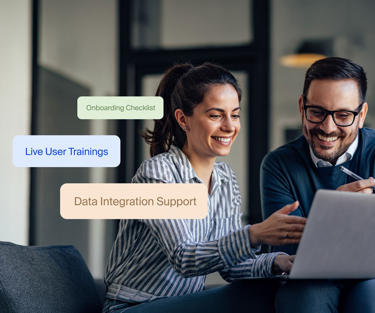 Team members reviewing onboarding checklist, live user trainings, and data integration support